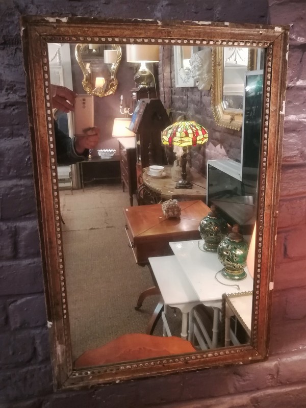 Beaded mirror in gilded wood