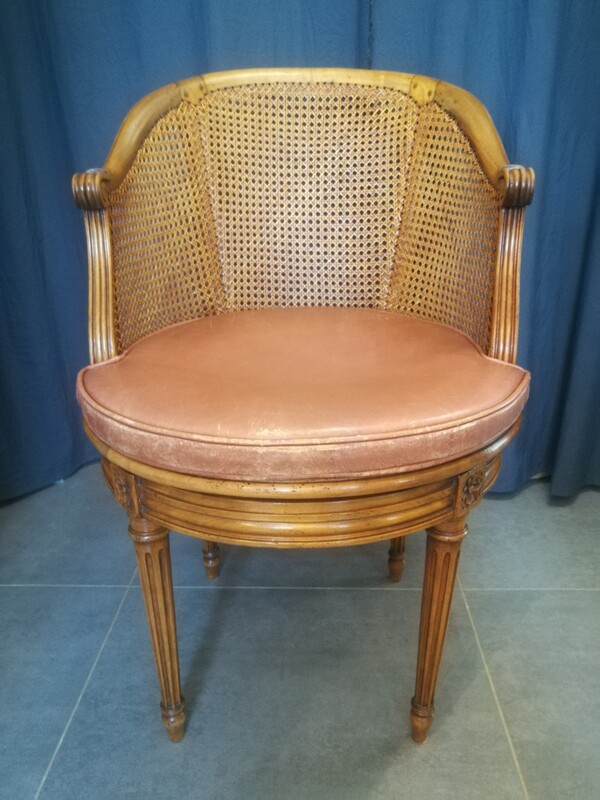 Cane and leather Louis XVI style rotating armchair