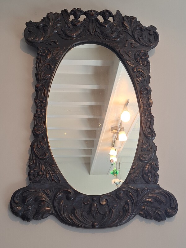 oak mirror carved with cherubs and acanthus leaves