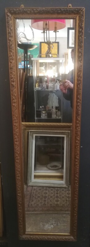 High and narrow gilt stucco mirror