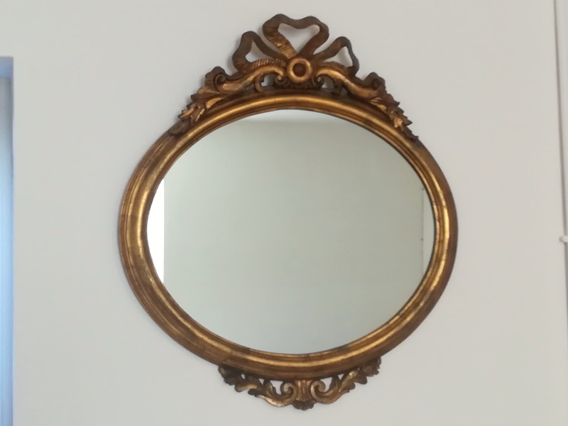 Gilded resin Louis XVI style oval mirror 