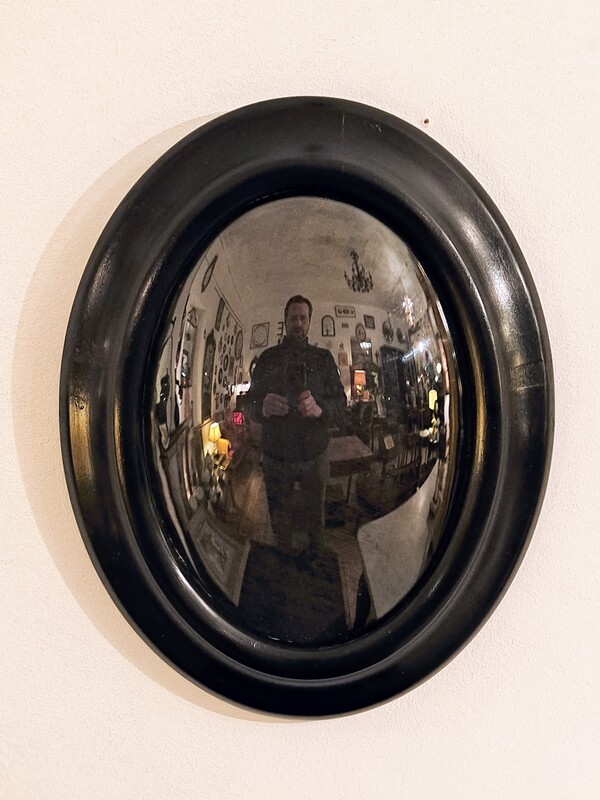 Oval frame in black lacquered wood with curved glass