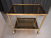 Rolling serving cart in gilded brass with smoked glass tops