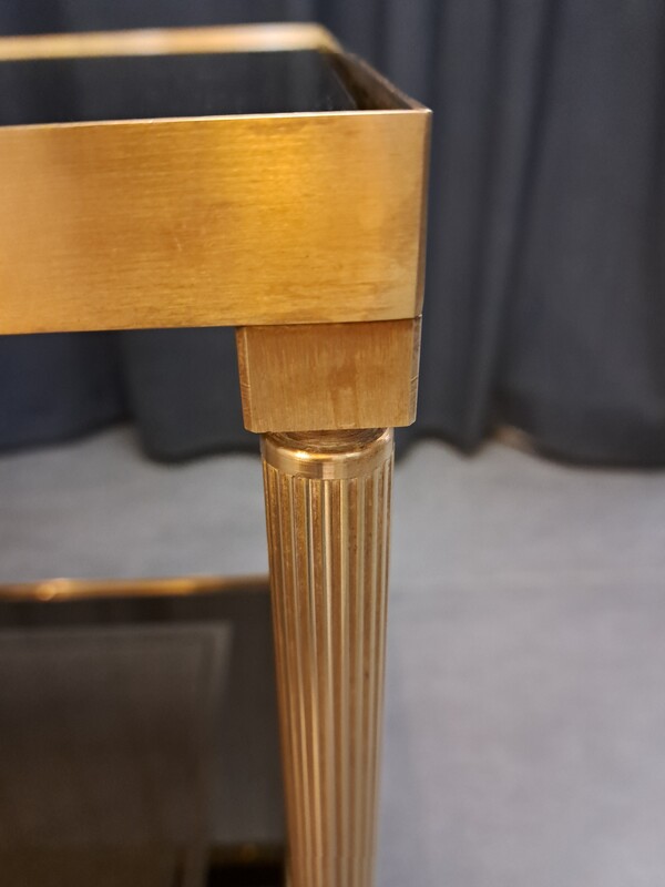 Rolling serving cart in gilded brass with smoked glass tops