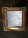 Small mirror in stucco and gilt leaf  