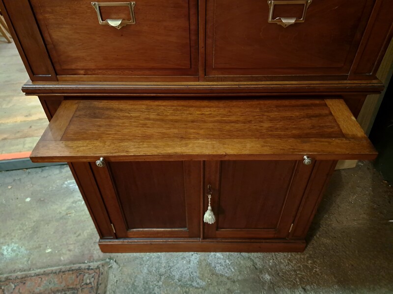  Two-piece mahogany notary's cabinet with hinged doors