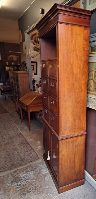  Two-piece mahogany notary's cabinet with hinged doors